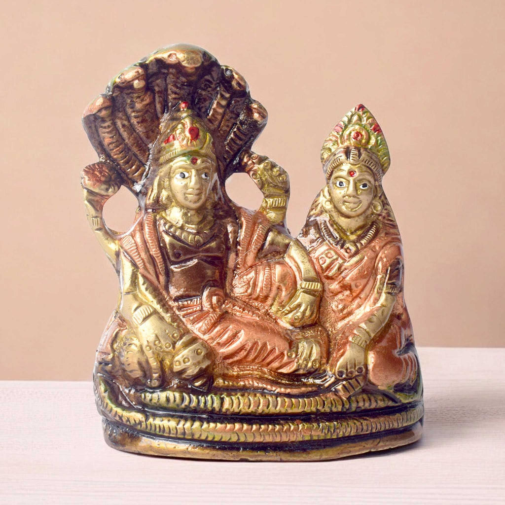  The 4.7 Inch Vishnu Ji Resting on Snake - Small Divine Figure is a beautifully crafted miniature statue that showcases Lord Vishnu in a serene and tranquil pose. Resting gracefully on the multi-headed serpent, Sheshnag, this divine figure symbolizes the eternal peace and protection Vishnu provides to the universe. 