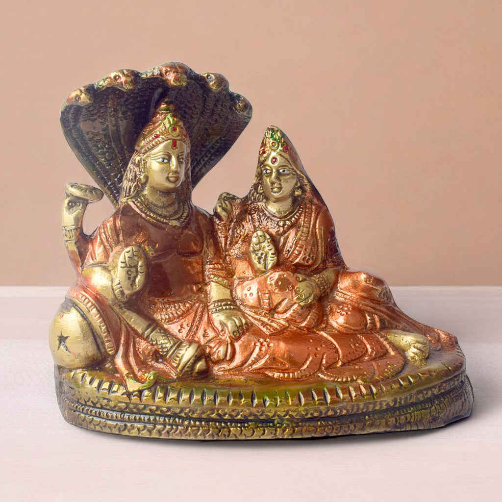  The 4.7 Inch Vishnu Ji Resting on Snake - Small Divine Figure is a beautifully crafted miniature statue that showcases Lord Vishnu in a serene and tranquil pose. Resting gracefully on the multi-headed serpent, Sheshnag, this divine figure symbolizes the eternal peace and protection Vishnu provides to the universe. 