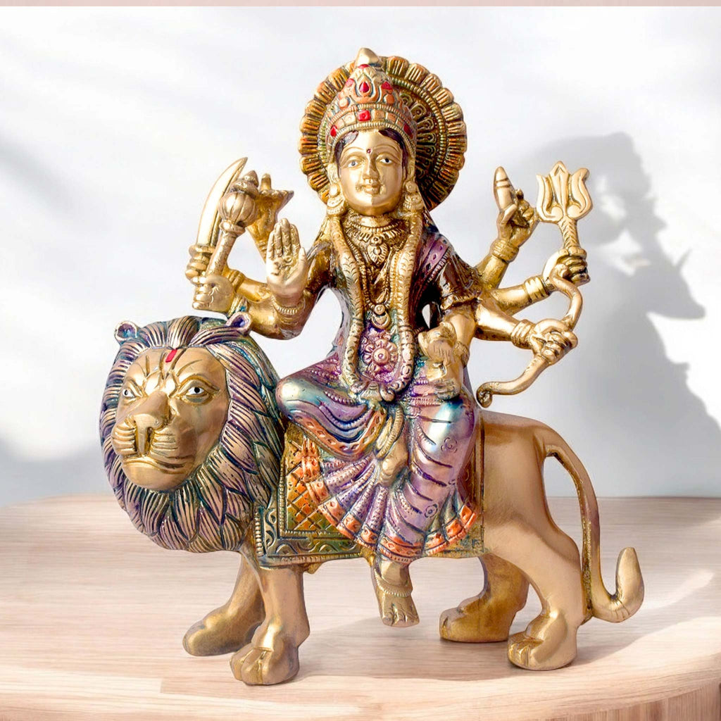 Embrace the powerful energy of Maa Durga with this 9-inch Brass 8-Armed Durga Idol, beautifully depicted riding her mighty lion. This meticulously crafted statue showcases Maa Durga in her most majestic form, symbolizing strength, courage, and divine protection.