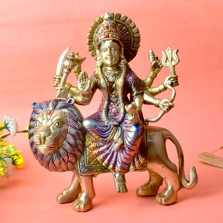 Embrace the powerful energy of Maa Durga with this 9-inch Brass 8-Armed Durga Idol, beautifully depicted riding her mighty lion. This meticulously crafted statue showcases Maa Durga in her most majestic form, symbolizing strength, courage, and divine protection.