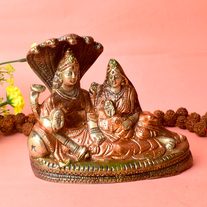  The 4.7 Inch Vishnu Ji Resting on Snake - Small Divine Figure is a beautifully crafted miniature statue that showcases Lord Vishnu in a serene and tranquil pose. Resting gracefully on the multi-headed serpent, Sheshnag, this divine figure symbolizes the eternal peace and protection Vishnu provides to the universe. 