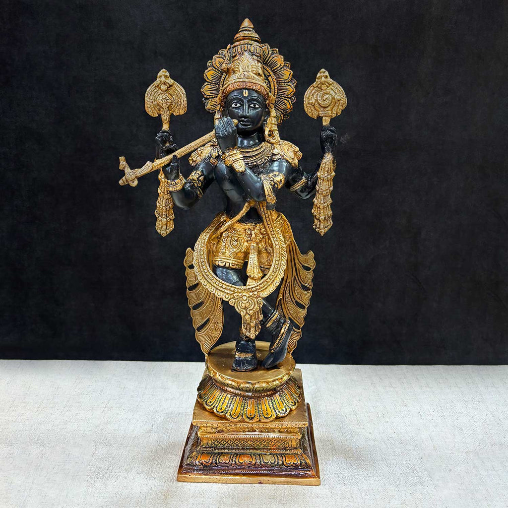 Bring home the divine charm of Lord Krishna with this exquisite 19-inch Brass Chola Krishna Sculpture. Expertly crafted, this statue captures Lord Krishna in his iconic pose, gracefully playing the flute.