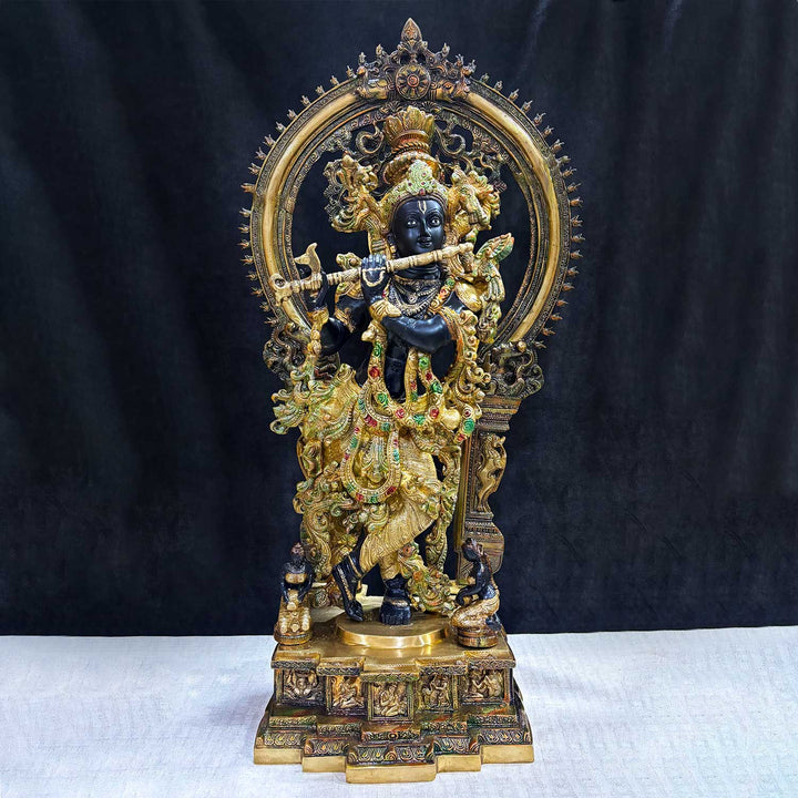 Bring divine elegance into your home with this stunning 32-inch Lord Krishna statue. Expertly crafted with intricate details, the statue beautifully portrays Lord Krishna in a serene and graceful stance. The engraved base adds a touch of traditional artistry, while the surrounding frame enhances its majestic presence.