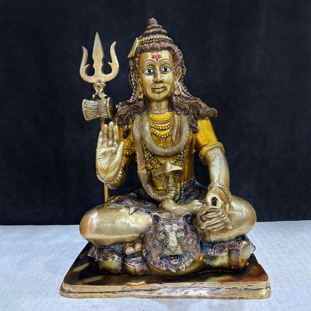 Embodying peace and spiritual focus, this 17.5-inch Brass Shiva Idol features Lord Shiva in a serene meditative posture. Known as the ultimate yogi, Lord Shiva is beautifully represented here with intricate detailing in brass, capturing the tranquility and profound wisdom of his meditation.