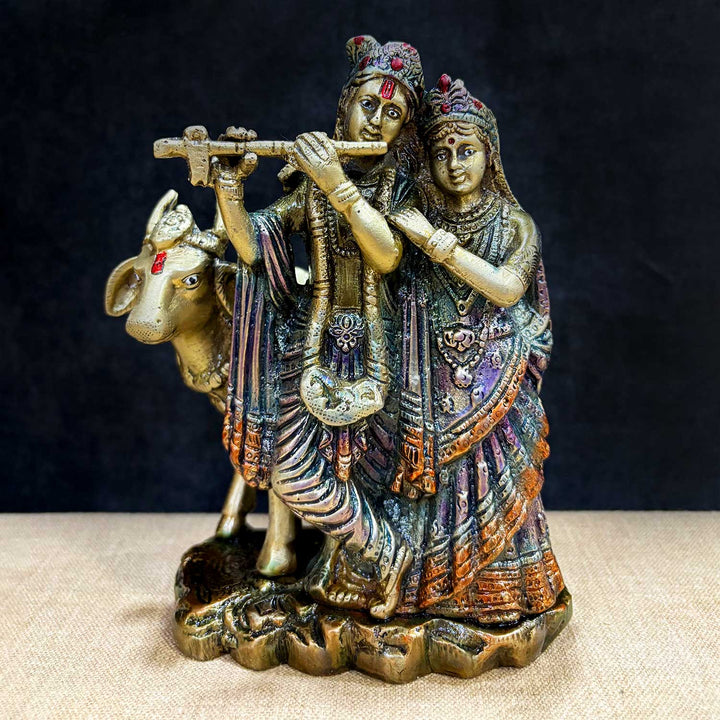 The 6.3 Inch Sacred Radha Krishna with Kamdhenu Cow Idol beautifully captures the divine union of Radha and Krishna, symbolizing love, harmony, and devotion. Crafted with intricate details, this idol features Radha and Krishna in an intimate and graceful pose, with Krishna playing his flute and Radha beside him, embodying the essence of their eternal bond.